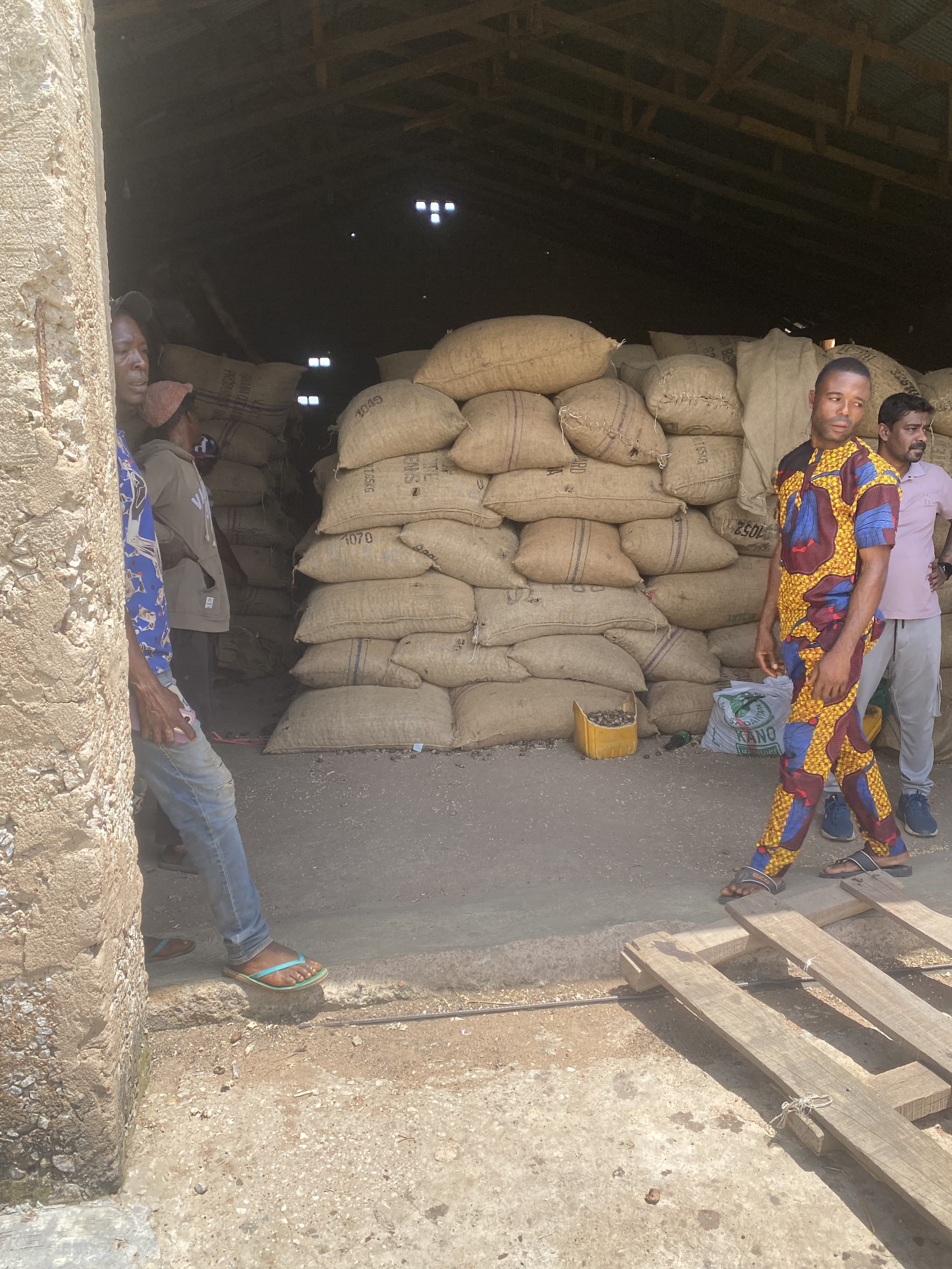 Inside a Rotscot commodity store — stacked jute bags of produce ready for export